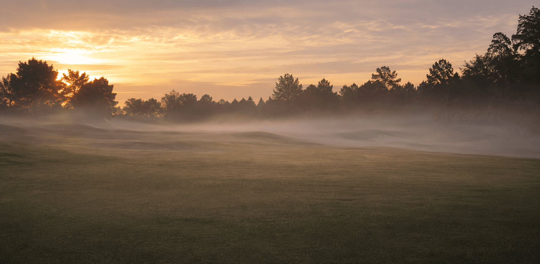 Golf course fairway at sunrise